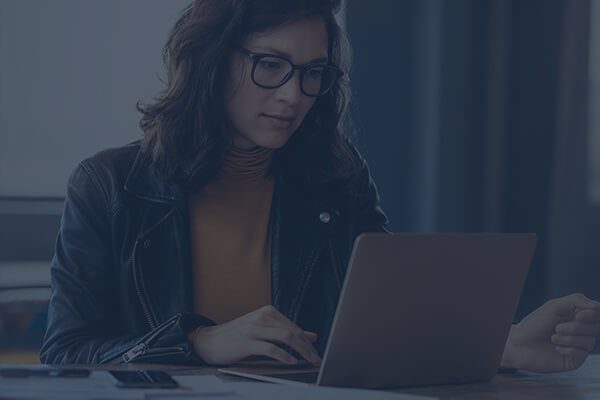 Woman Reviewing Intelligence on Her Laptop